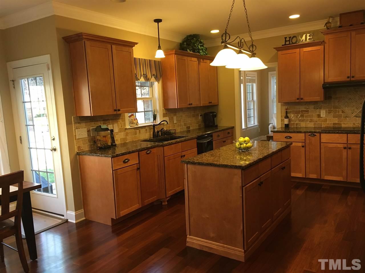 8114 Dreamy Way Raleigh, NC 27613 - Photo 7 of 22 a kitchen with a sink stove and cabinets