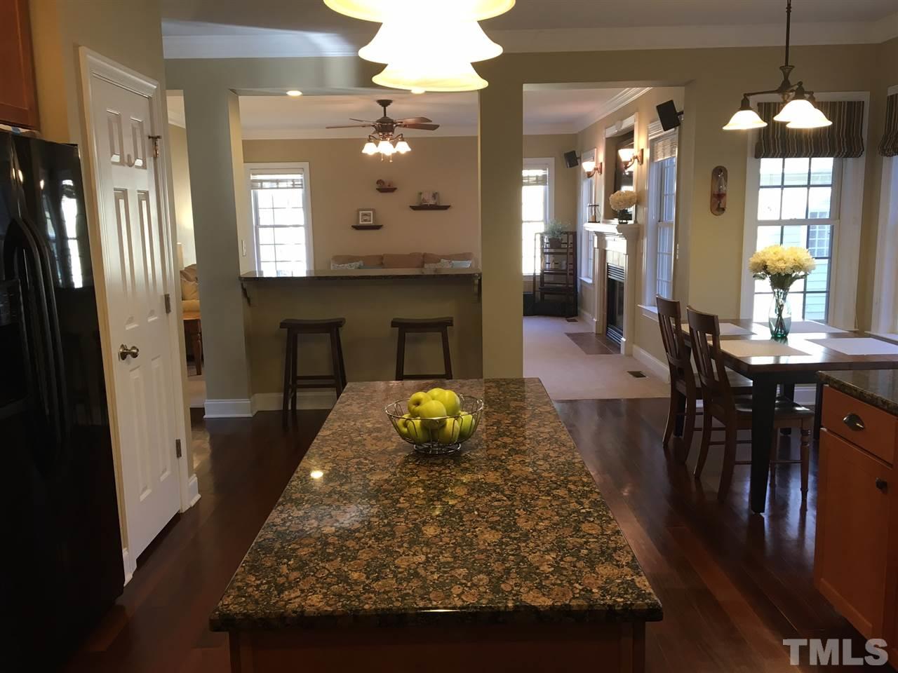 8114 Dreamy Way Raleigh, NC 27613 - Photo 8 of 22 a living room with dining table and wooden floor
