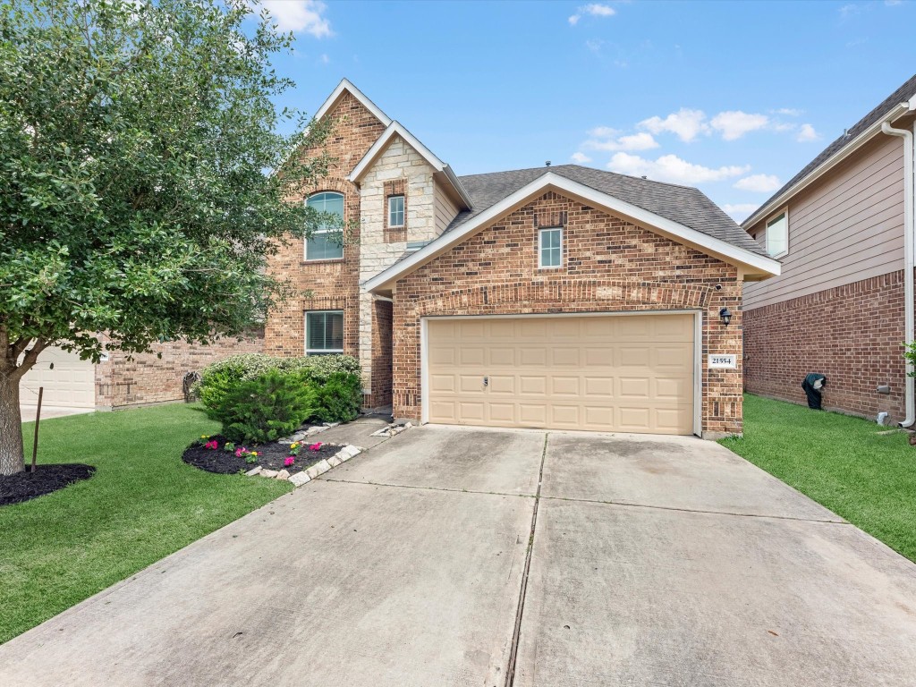 Welcome home!  Charming brick home with a well-maintained front yard, featuring a two-car garage and a neatly landscaped low maintenance lawn.
