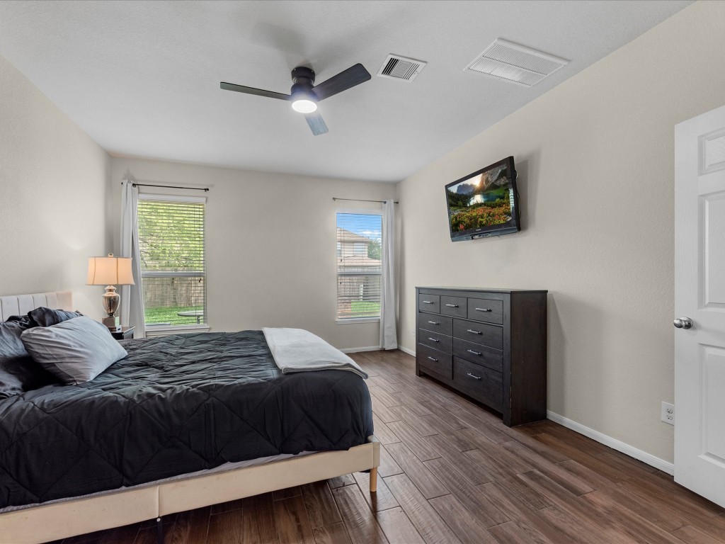 21554 Rainfall Park Drive Spring, TX 77388 - Photo 15 of 36 Primary bedroom is located conveniently on the main floor and has an ensuite full bathroom.