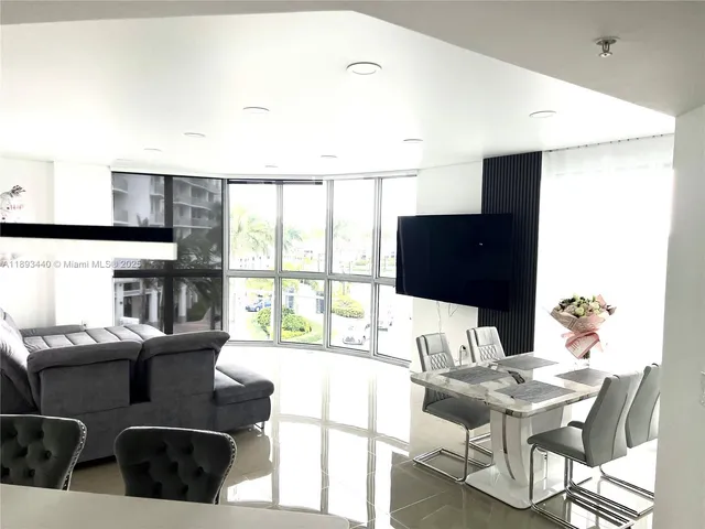 a spacious bedroom with a bed and a chandelier