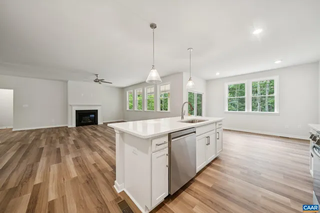 a kitchen with a stove and a wooden floor