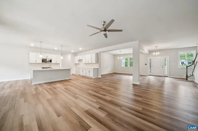 a view of kitchen and hall with wooden floor