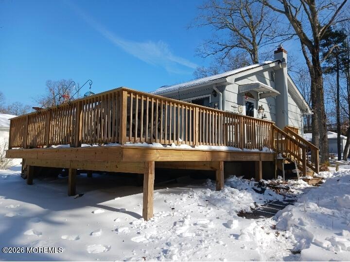 115 Pension Road Manalapan, NJ 07726 - Photo 12 of 19 a view of a house with a wooden deck and a forest