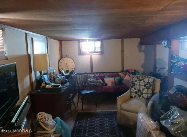 a living room with furniture and a mirror