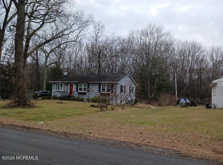 115 Pension Road Manalapan, NJ 07726 - Photo 2 of 19 a view of a big house with a big yard and large trees