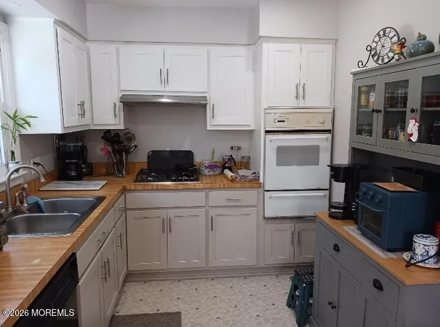 a kitchen with cabinets appliances and a sink