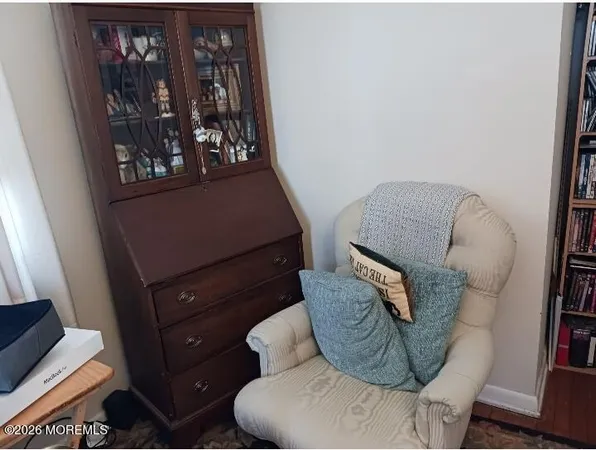 a living room with furniture and baby crib