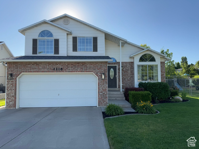 Undisclosed Address Layton, UT 84041 - Photo 1 of 1 Traditional-style home featuring concrete driveway, brick siding, and a garage