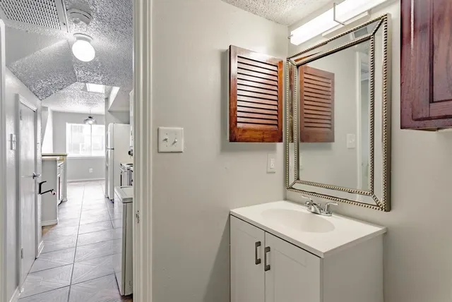 a bathroom with a sink a mirror and a shower