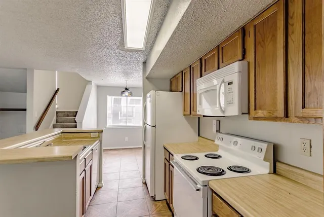 a kitchen that has a sink and a wooden floor