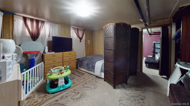 a bedroom with furniture and a flat screen tv