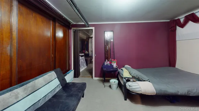 a bedroom with bed and a mirror