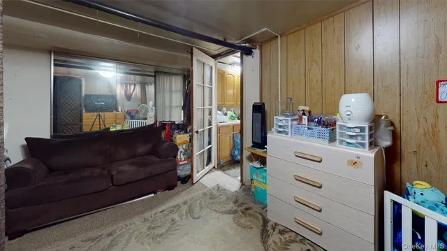 a living room with furniture and a dresser