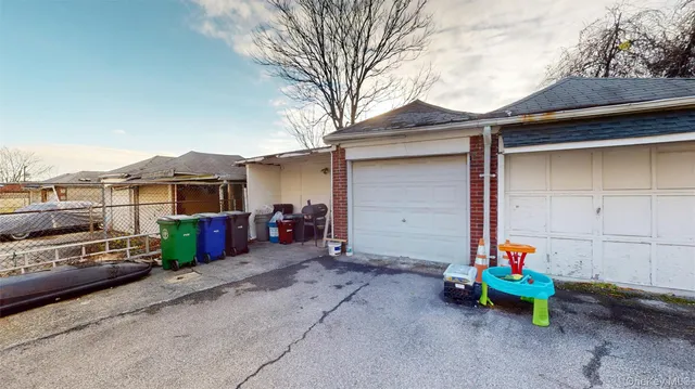 a view of a chairs and table in backyard of the house