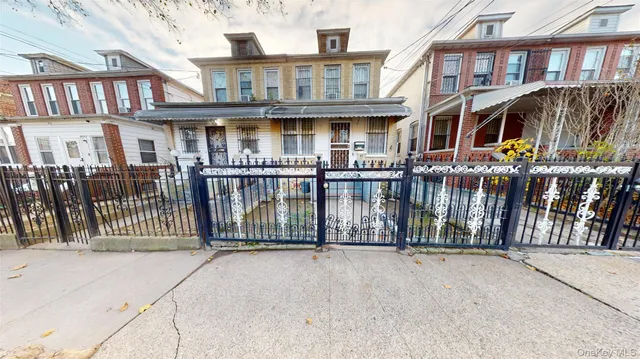 a view of a brick house with large windows