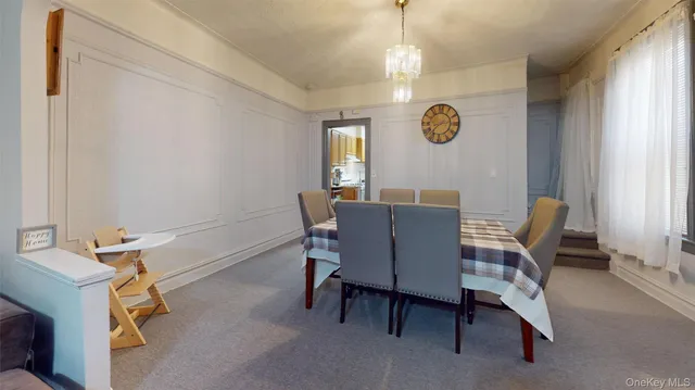 a view of a dining room with furniture and a window