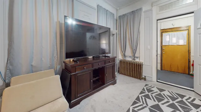 a view of a livingroom with furniture and an entryway