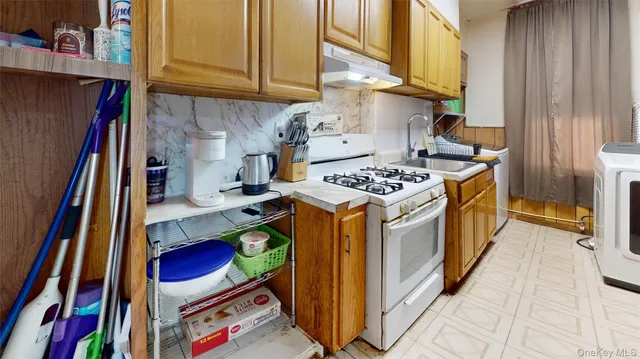 a kitchen with stainless steel appliances granite countertop a stove and a refrigerator