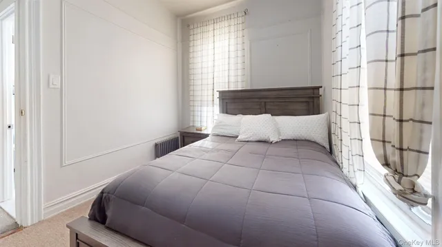 a bedroom with a bed and window