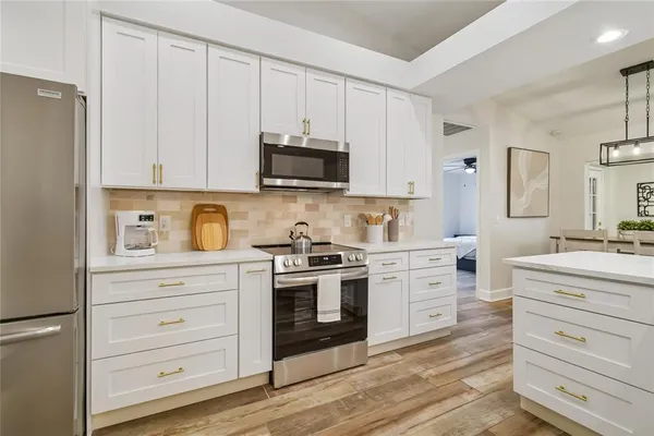 a dining room with wooden floor a chandelier