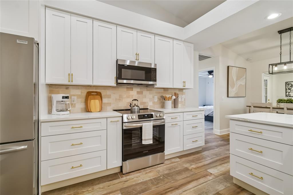 2513 North Valrico Road Seffner, FL 33584 - Photo 17 of 76 a kitchen with granite countertop white cabinets and stainless steel appliances