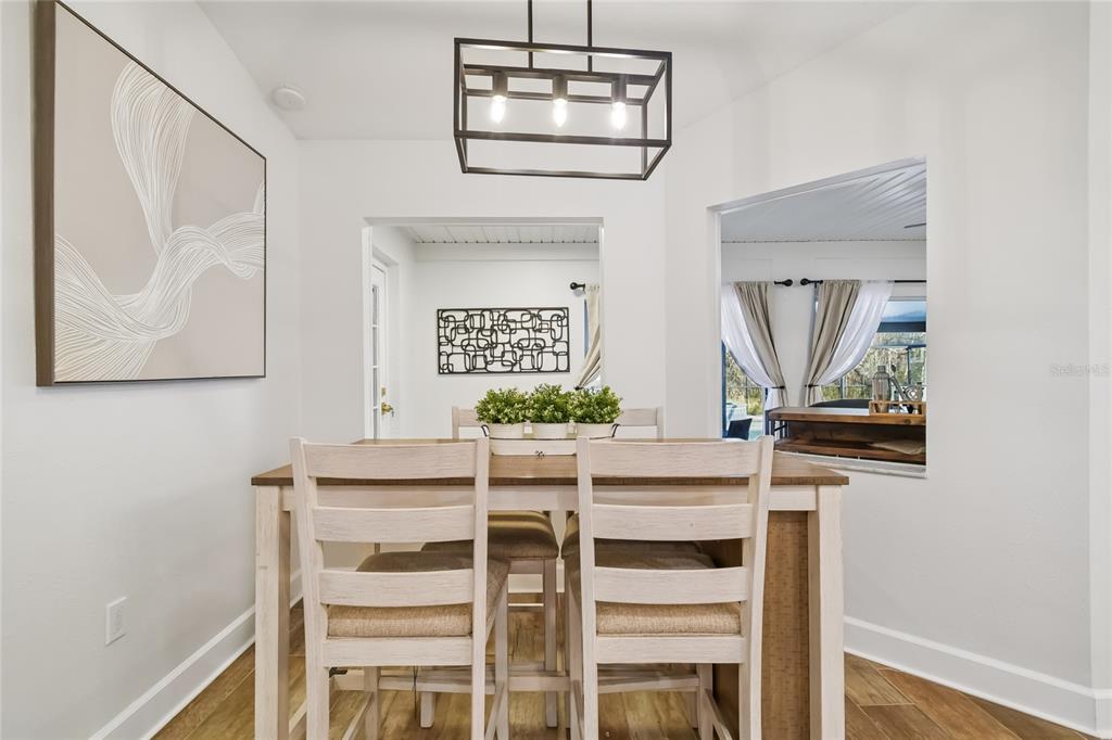 2513 North Valrico Road Seffner, FL 33584 - Photo 20 of 76 a dining room with wooden floor a chandelier