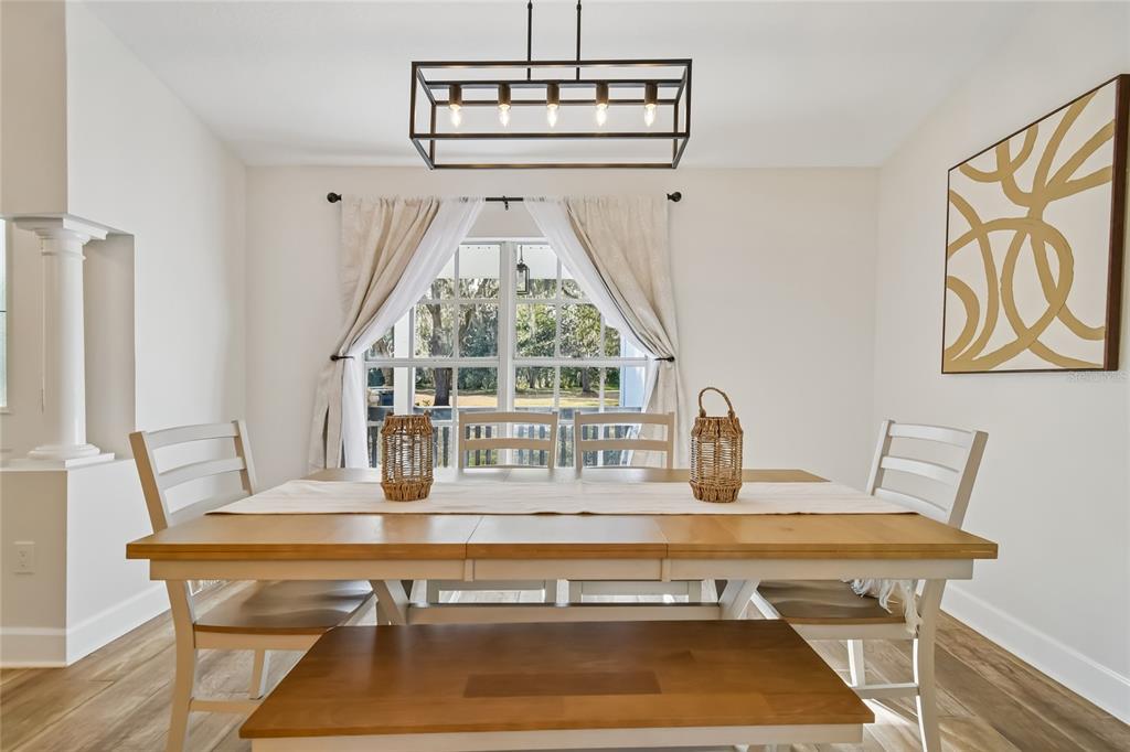 2513 North Valrico Road Seffner, FL 33584 - Photo 22 of 76 a view of a dining room with furniture wooden floor and a chandelier