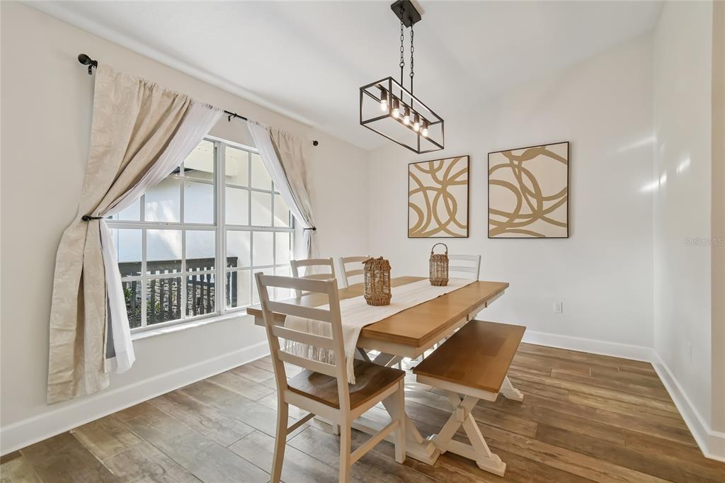 2513 North Valrico Road Seffner, FL 33584 - Photo 23 of 76 a view of a dining room with furniture wooden floor and chandelier