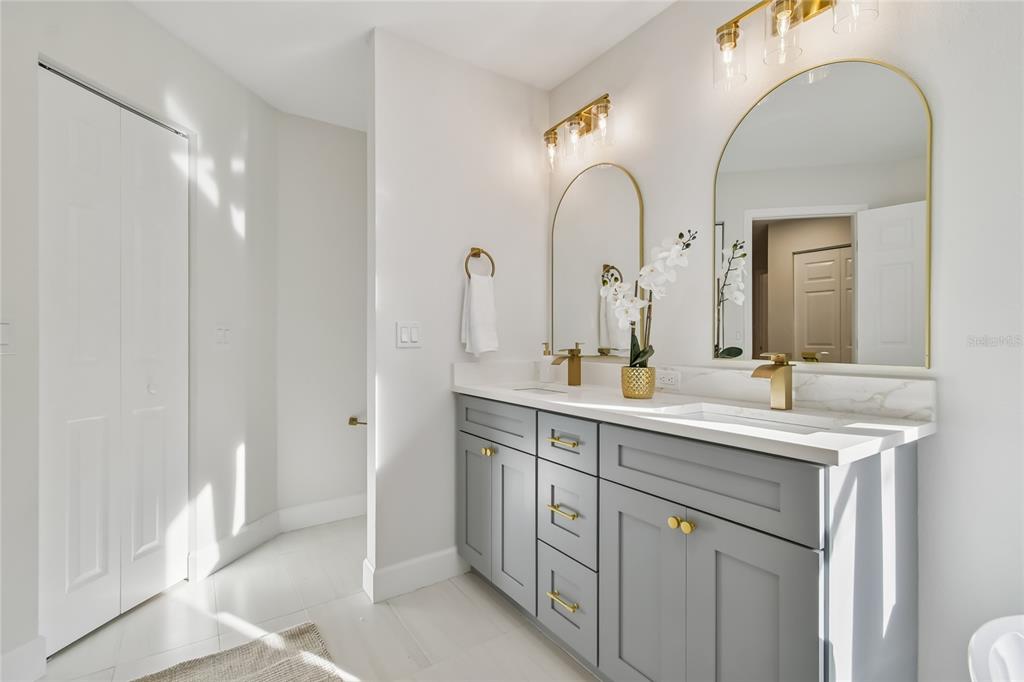 2513 North Valrico Road Seffner, FL 33584 - Photo 28 of 76 a bathroom with a double vanity sink and a mirror
