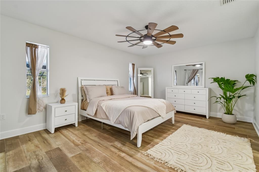 2513 North Valrico Road Seffner, FL 33584 - Photo 30 of 76 a bedroom with a large bed and a chandelier