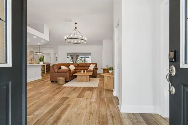 a living room with furniture and a chandelier