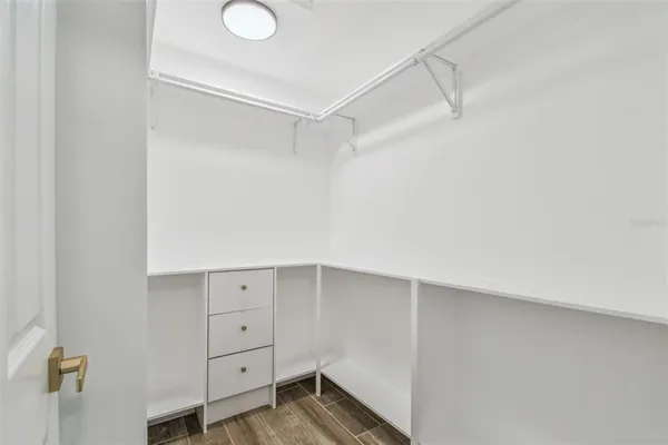 a bed room with a bed and a mirror