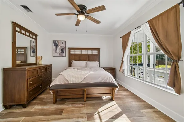 a bedroom with a bed potted plant with the window