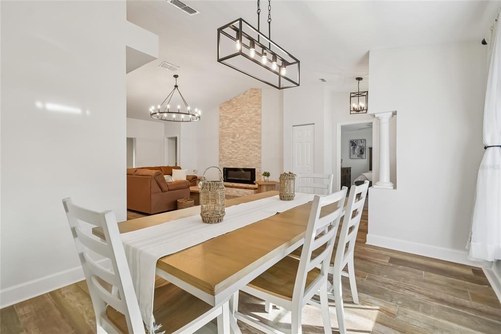 2513 North Valrico Road Seffner, FL 33584 - Photo 4 of 76 a dining room with furniture a chandelier and wooden floor