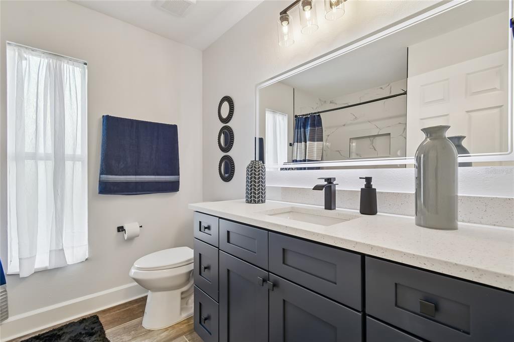 2513 North Valrico Road Seffner, FL 33584 - Photo 44 of 76 a bathroom with a toilet a sink and mirror