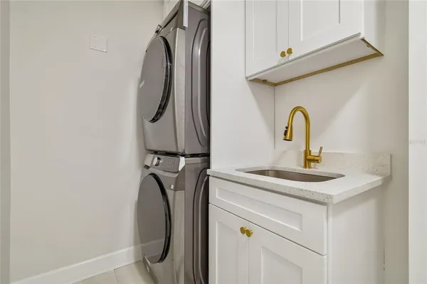 a front view of a house with garden and tree