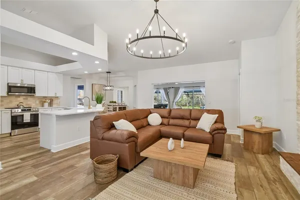 a living room with furniture kitchen and a table