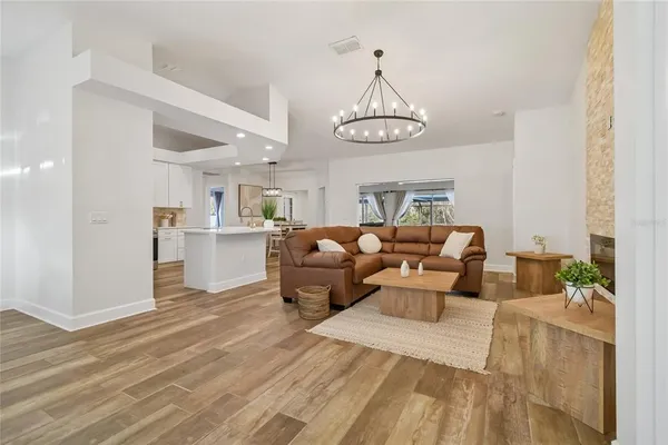 a kitchen with a sink stove and wooden floor