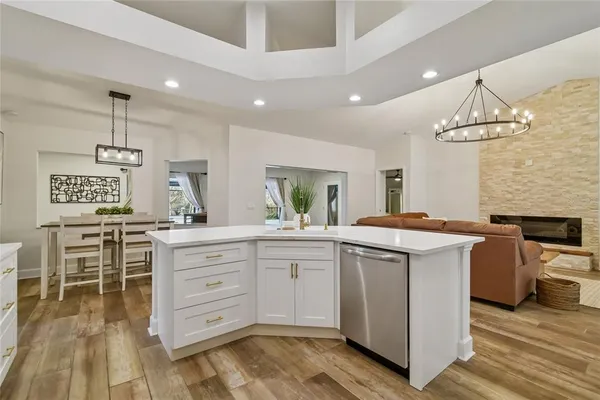 a kitchen with granite countertop a sink appliances and cabinets