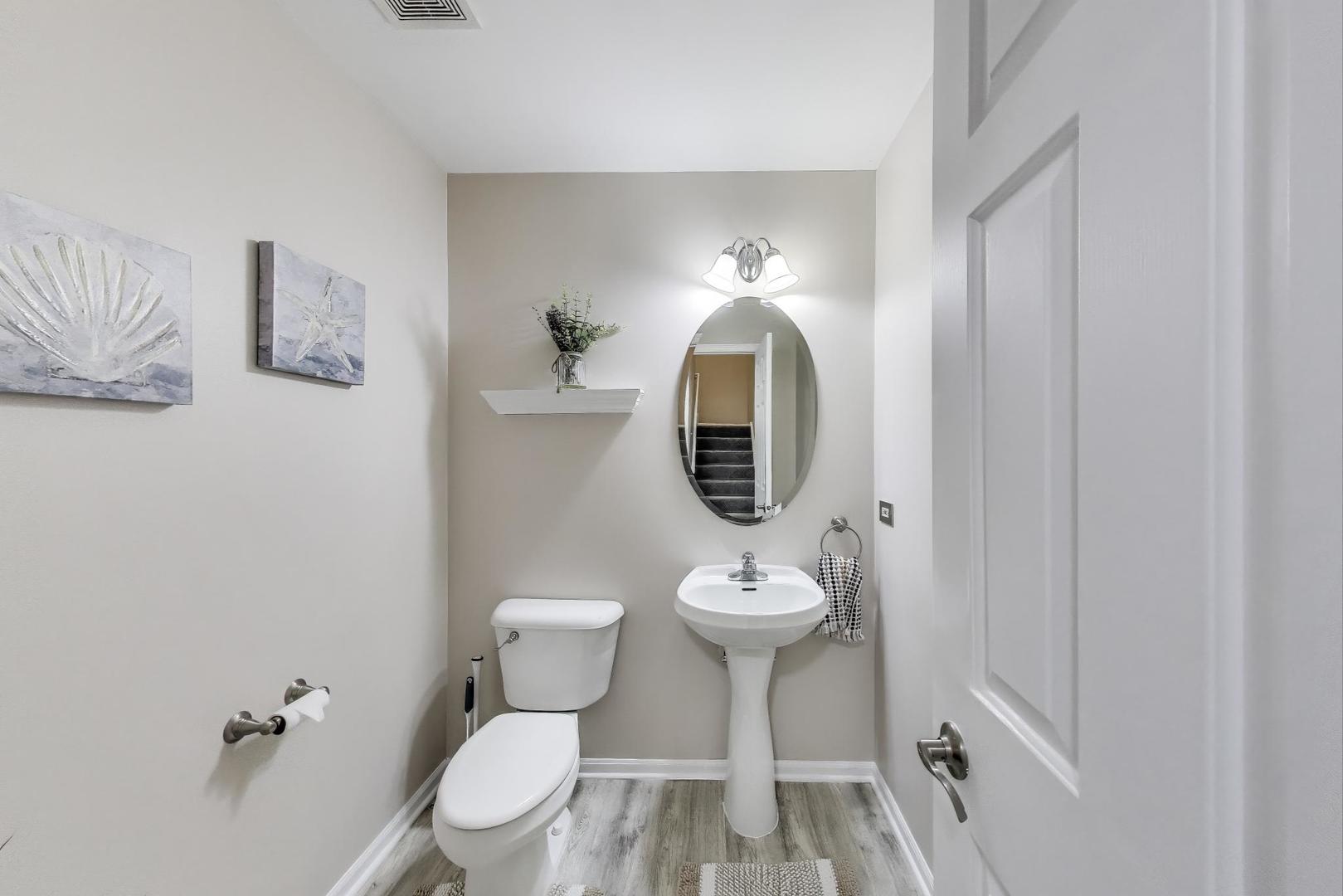 532 Declaration Lane Aurora, IL 60502 - Photo 12 of 34 a bathroom with a toilet sink a mirror and vanity