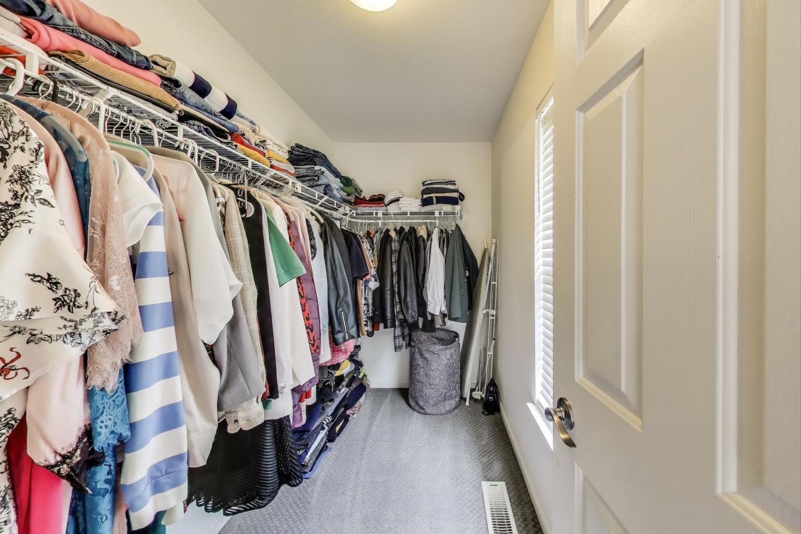 532 Declaration Lane Aurora, IL 60502 - Photo 16 of 34 a view of walk in closet with clothes