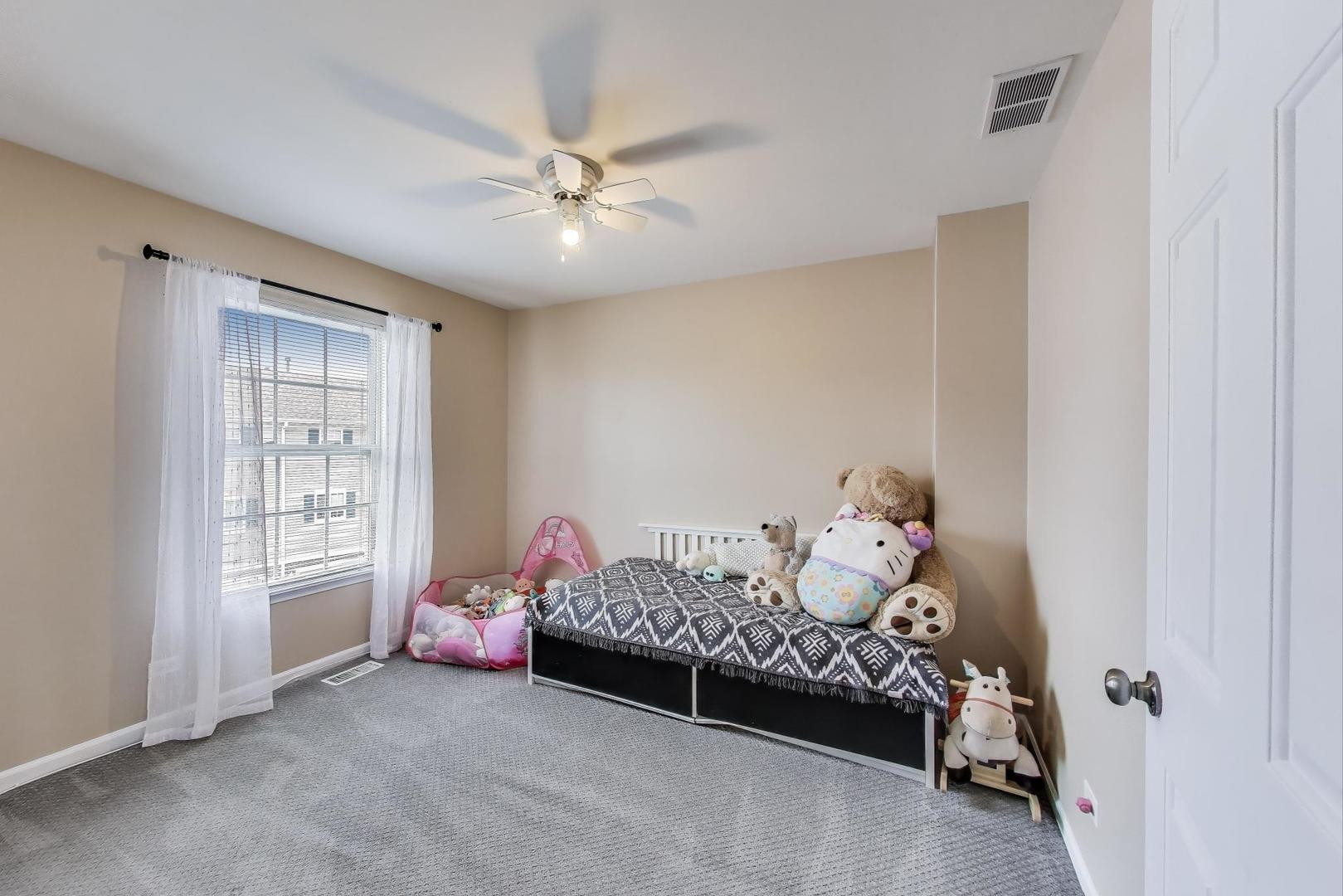 532 Declaration Lane Aurora, IL 60502 - Photo 21 of 34 a bedroom with furniture and a window