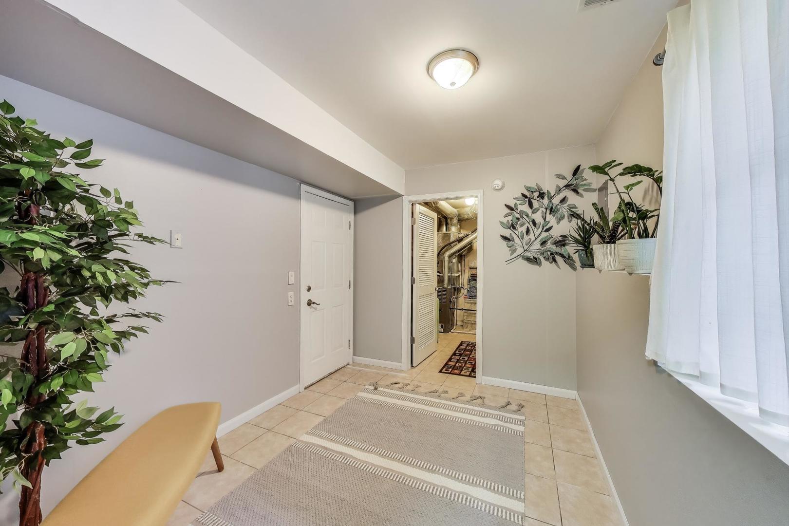 532 Declaration Lane Aurora, IL 60502 - Photo 23 of 34 a bedroom with a bed and a plant