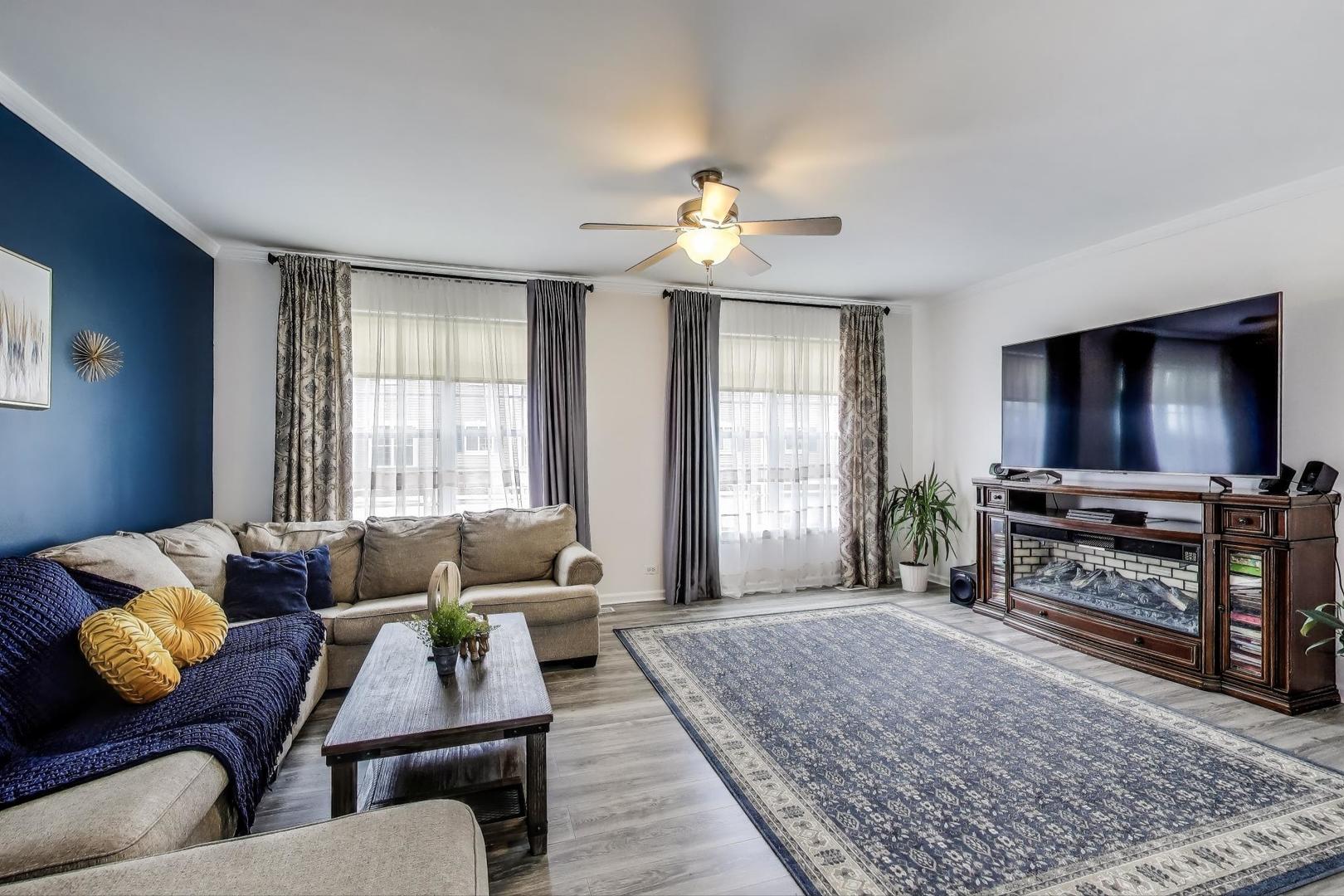 532 Declaration Lane Aurora, IL 60502 - Photo 3 of 34 a living room with furniture and a flat screen tv