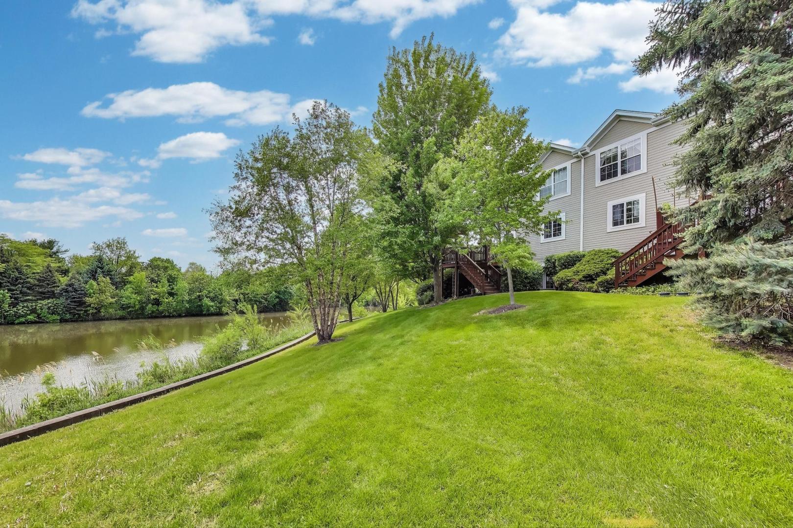 532 Declaration Lane Aurora, IL 60502 - Photo 31 of 34 a view of a lake with a yard