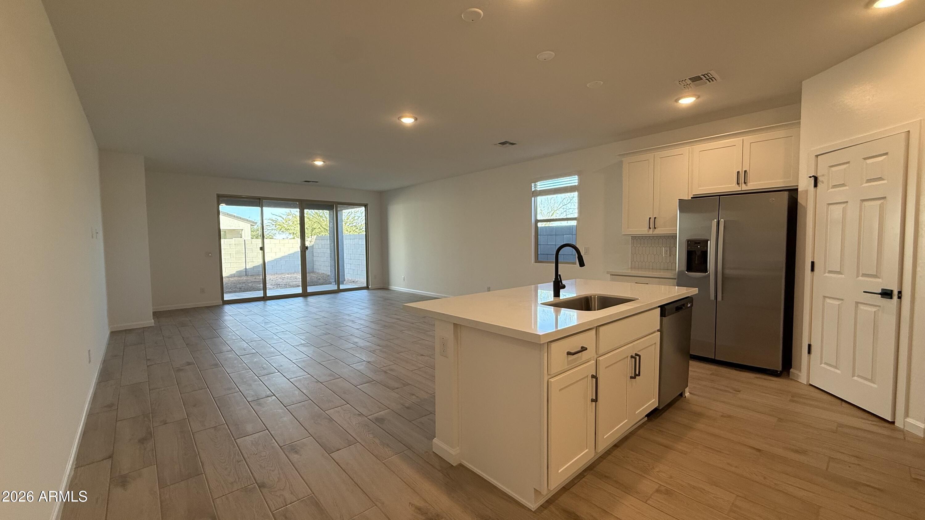 46818 West Old Timer Road Maricopa, AZ 85139 - Photo 11 of 34 a kitchen with a stove a sink and a refrigerator