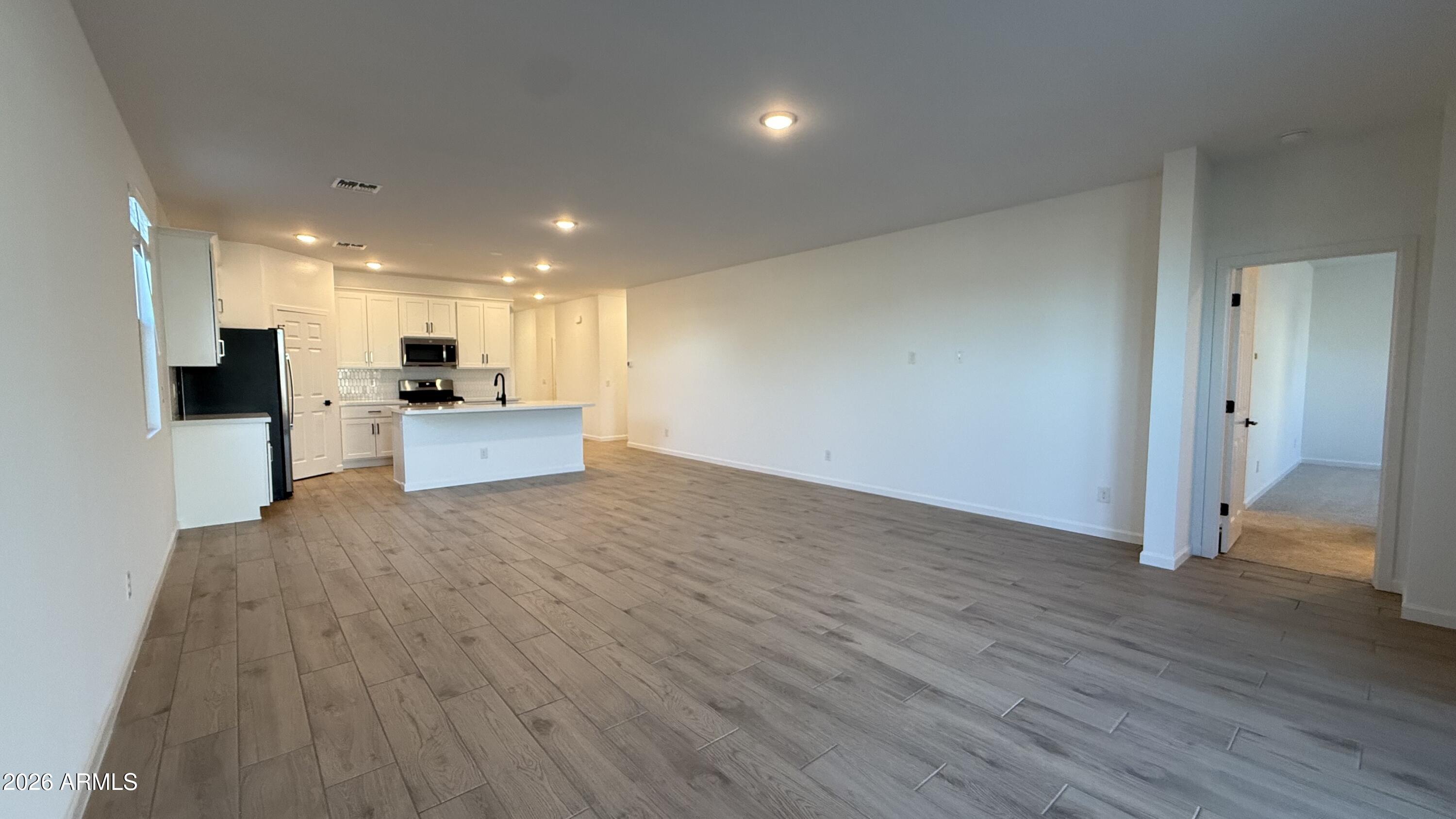 46818 West Old Timer Road Maricopa, AZ 85139 - Photo 15 of 34 a view of empty room with wooden floor