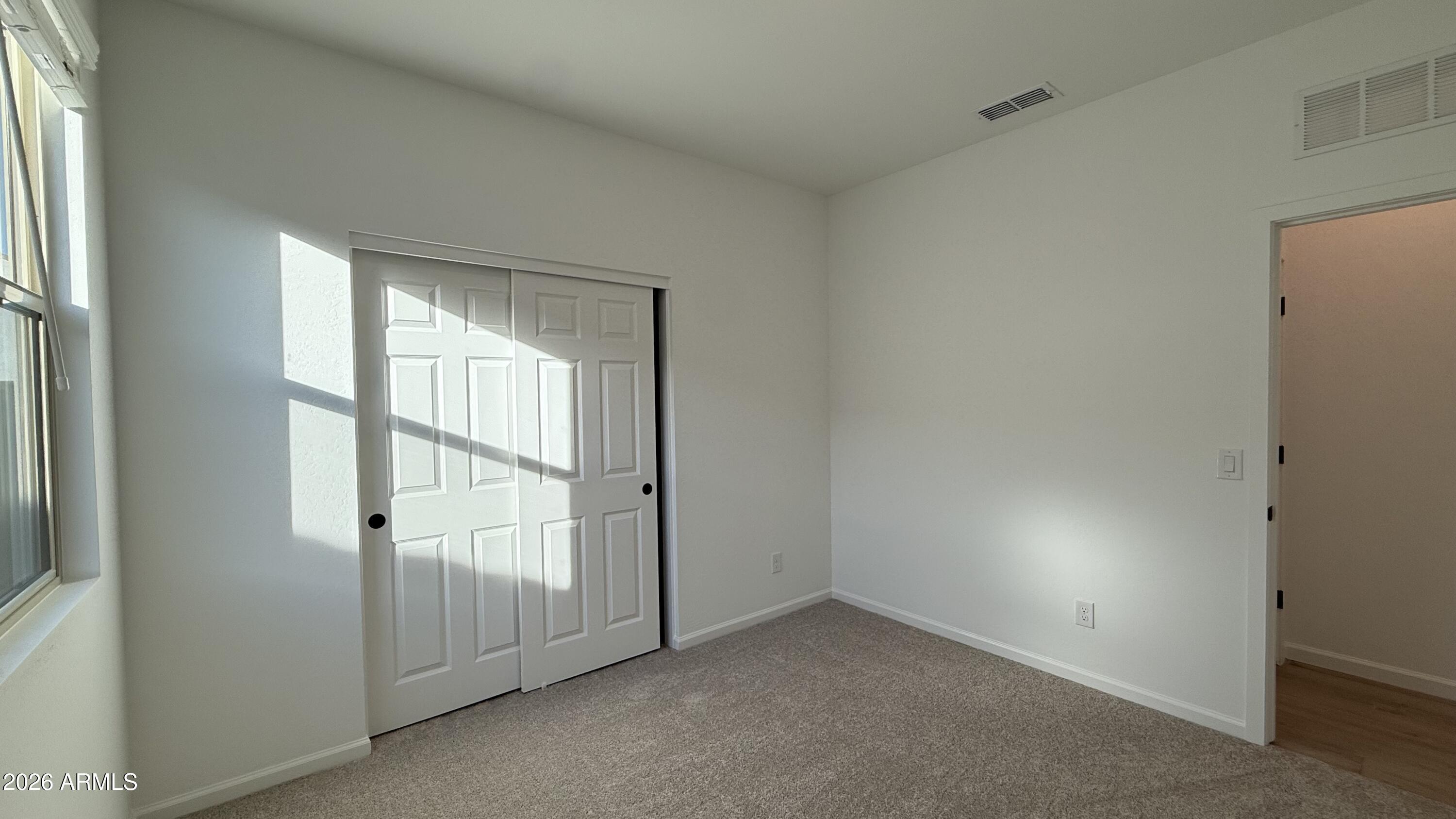 46818 West Old Timer Road Maricopa, AZ 85139 - Photo 26 of 34 an empty room with windows