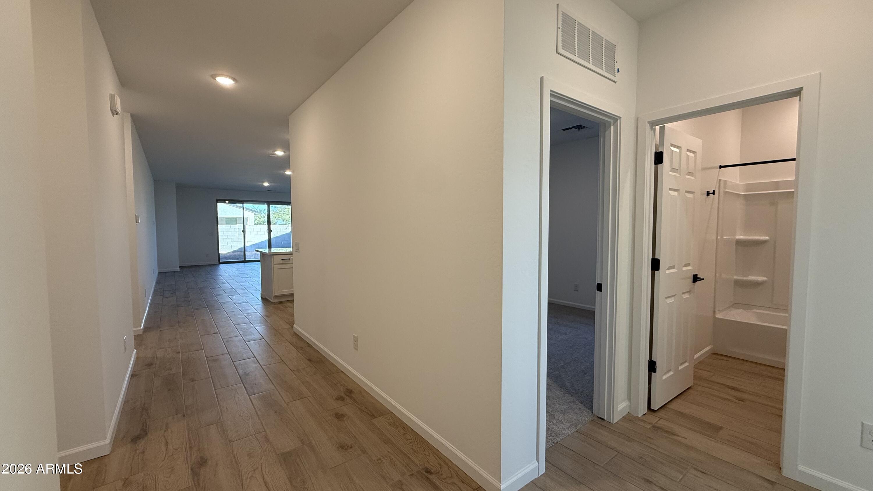 46818 West Old Timer Road Maricopa, AZ 85139 - Photo 5 of 34 a view of a hallway with wooden floor and closet area